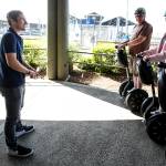 Gregg Jantz Jr. (left) goes through a few tips with Segway riders before they head out to explore the Edmonds waterfront. Jantz founded Edmonds Segway Tours five years ago when he was just 12 years old. (Ian Terry / The Herald)