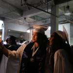 Glacier Peak High School seniors Kayla Watkins (left) and Areha Jackson take a selfie photo together before their graduation ceremony at Xfinity Arena on Monday in Everett. (Andy Bronson / The Herald)