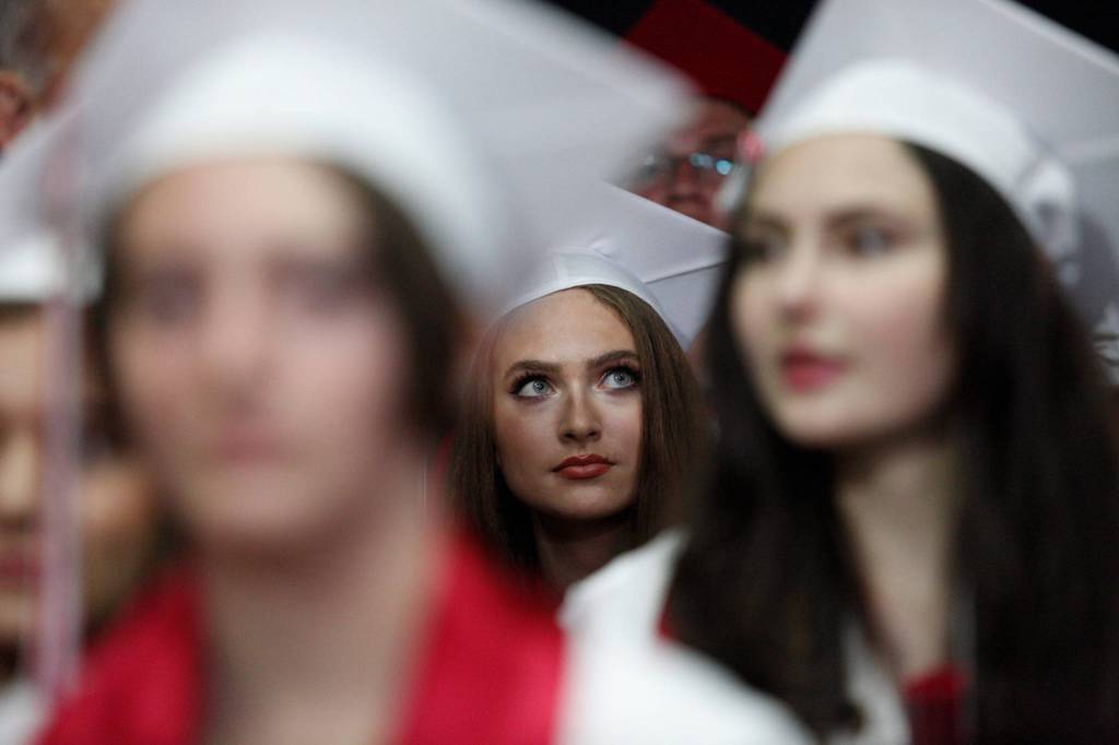A Snohomish High senior scans the arena before the start of her graduation ceremony at Xfinity Arena on Monday in Everett. (Andy Bronson / The Herald)