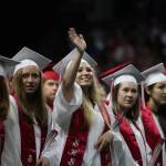 Snohomish High&rsquo;s Mayah Chisa waves to family as she and classmates get seated for their graduation ceremony at Xfinity Arena on Monday in Everett. (Andy Bronson / The Herald)
