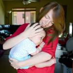 Heaven Reel, 18, hugs her 7-month-old daughter, Alma Ramirez, in their Bozeman, Montana, apartment on June 7. (Rachel Leathe / Bozeman Daily Chronicle)