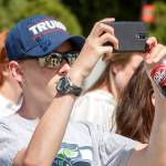 Bryce Howard, 15, of Everett, wears a Trump hat as he snaps a photo during a visit to the Supreme Court in Washington on Monday, where justices issued their final rulings for the term. The high court is letting a limited version of the Trump administration ban on travel from six mostly Muslim countries take effect. (AP Photo/J. Scott Applewhite)