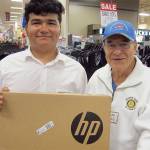 Working with long-time Rotarian Ralph Quaas (right) Cascade High graduate Alexis Luna chose an HP laptop computer during his Fred Meyer College Essentials shopping trip. (Contributed photo)