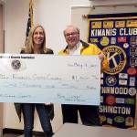 Debbie Purser of North Central Seattle Kiwanis receives a $1,000 check from Lynnwood Kiwanis President Ron Swengel on May 4 to help support Kiwanis Camp Casey. (Contributed photo)