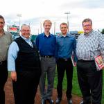 Pat Castro (second from left) leads the choir group Common Ground, pictured here after singing at an AquaSox game. (Submitted photo)