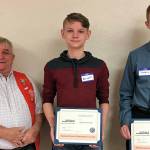 Snohomish Tillicum Kiwanis treasurer John Bruce congratulates Orion Presler and Timothy Matson as Dux Award winners. (Contributed photo)