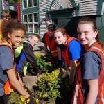 Everett Christian School students (from left) Gigi O&rsquo;Neal, Jake Van Loo, Devin Hibma, Abby Steinberg and Josephine Swinburnson help plant flowers May 19 in downtown Everett as part of the school&rsquo;s Serve-a-Thon. (Contributed photo)
