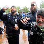 Two men protesting with the conservative group Patriot Prayer react after they said they were sprayed with pepper spray and doused with glitter by counter-protesters Thursday at The Evergreen State College in Olympia. (AP Photo/Ted S. Warren)