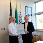 Michael Kidd, United States Navy captain, retired, presents Everett schools Superintendent Gary Cohn with the 2017 Secretary of Defense Freedom Award nominee certificate. (Contributed photo)