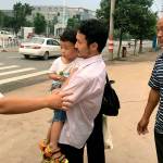 Chinese labor activist Hua Haifeng (center) carries his son, Bobo, and is greeted by his sister Hua Xiaoqin (left) as he leaves a police station after being released in Ganzhou in southern China&rsquo;s Jiangxi Province on Wednesday. Chinese authorities released on bail three activists who had been detained after investigating labor conditions at a factory that produced shoes for Ivanka Trump and other brands. (AP Photo/Gerry Shih)