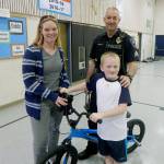 Mountlake Terrace police detective Heidi Froisland and Sgt. Scott Burkett meet with Jack Chalmers, 8. Police used a benevolent fund to replace Jack&rsquo;s stolen bike. (Mountlake Terrace Police)