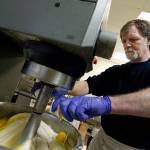 Masterpiece Cakeshop owner Jack Phillips cracks eggs into a cake batter mixer at his store in Lakewood, Colorado. The Supreme Court said it will consider whether a baker who objects to same-sex marriage on religious grounds can refuse to make a wedding cake for a gay couple. (AP Photo/Brennan Linsley, File)
