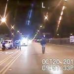 In this Oct. 20, 2014 image taken from dash-cam video, Laquan McDonald (right) walks down the street moments before being fatally shot by Chicago Police officer Jason Van Dyke in Chicago. (Chicago Police Department via AP, File)