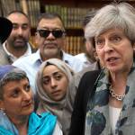 British Prime Minister Theresa May (right) talks to faith leaders at Finsbury Park Mosque in north London after a van struck pedestrians Monday. (Stefan Rousseau/Pool Photo via AP)