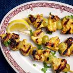 Grilled grapes provide a sweet counterpoint to the savory of spiced chicken skewers. (Photo by Deb Lindsey for The Washington Post)