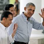 Former U.S. President Barack Obama waves to reporters as he walks with Indonesian President Joko Widodo (left) upon arrival for their meeting at the Bogor Presidential Palace in Bogor, West Java, Indonesia, on Friday. Obama and his family arrived Friday in his childhood home of Jakarta on the tail-end of their 10-day vacation to the country, where they were spotted whitewater rafting and visiting ancient temples. (AP Photo/Dita Alangkara, Pool)