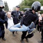 Police detain a protester during an anti-corruption rally in St. Petersburg, Russia, on Monday. (AP Photo/Dmitry Lovetsky)