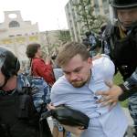 Police detain a protester during a demonstration in downtown Moscow, Russia, on Monday. (AP Photo/Pavel Golovkin)