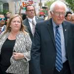 In this July 2016 photo, Sen. Bernie Sanders, I-Vt. and his wife, Jane O&rsquo;Meara Sanders, walk through downtown in Philadelphia during the final day of the Democratic National Convention. (AP Photo/John Minchillo, File)