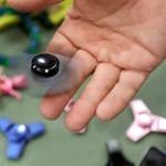 Funky Monkey Toys store owner Tom Jones plays with a fidget spinner in Oxford, Michigan. Fidget spinners are among the those on the annual list of hazardous summer toys compiled by World Against Toys Causing Harm Inc., a nonprofit consumer watchdog. (AP file )