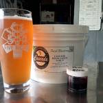 A glass of 5 Rights Brewing&rsquo;s 2nd Anniversary Celebration Saison sits next to the blueberry-pomegranate candi syrup that gives it its unique flavor. (Aaron Swaney / For The Herald)