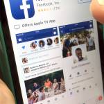 This 19 photo shows Facebook launched on an iPhone in North Andover, Massachusetts. (AP Photo/Elise Amendola)
