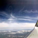 A plane flies over the Pacific Northwest on May 29. (Sue Misao / The Herald)