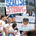 Supporters of House Majority Whip Steve Scalise, R-La., hold signs before the Congressional baseball game on Thursday, June 15, in Washington. (AP Photo/Alex Brandon)