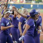 Washington&rsquo;s Kirstyn Thomas (right front) celebrates with teammates after hitting a two-run home run in the seventh inning against Oregon in an NCAA Women&rsquo;s College World Series game June 1 in Oklahoma City. (Bryan Terry/The Oklahoman via AP)