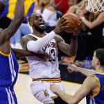 Cavaliers forward LeBron James (23) drives on the Warriors&rsquo; Draymond Green (23) and Klay Thompson (11) in the first half of Game 4 of the NBA Finals on June 9, 2017, in Cleveland. (AP Photo/Ron Schwane)