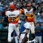 The Astros George Springer (right) celebrates with Josh Reddick (22) at home after Reddick&rsquo;s home run as Mariners catcher Carlos Ruiz looks on during the third inning of a game June 24, 2017, in Seattle. (AP Photo/Jason Redmond)