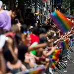 People line the street with rainbow flags as they watch the New York City Pride Parade on Sunday, June 25, 2017 in New York. (AP Photo/Michael Noble Jr.)