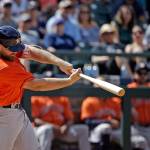 Houston Astros&rsquo; Evan Gattis belts a two-run home run against the Seattle Mariners in the ninth inning Sunday, June 25, 2017, in Seattle. (AP Photo/Elaine Thompson)