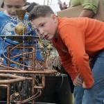 Ethan Stuehrenberg, 8, of Everett, checks out a water garden sculpture by Vancouver B.C. artist Douglas Walker during the 2012 Edmonds Arts Festival at the Frances Anderson Center. (For the Herald/Doug Ramsay)