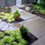 The &ldquo;after&rdquo; photo showing how a client&rsquo;s lawn was replaced with colorful plants, a path and a bench. As a fence was added in the redesign, this view is from the front porch. (Pam Roy / For The Herald)