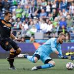 Ted S. Warren / Associated Press                                Seattle Sounders goalkeeper Stefan Frei dives on the ball as Houston Dynamo forward Erick Torres closes in during the first half of an MLS match Sunday in Seattle.
