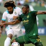 Seattle&rsquo;s Roman Torres and Portland&rsquo;s Fanendo Adi battle for the ball during an MLS game Sunday in Portland, Oregon. (Pete Christopher/The Oregonian via AP)
