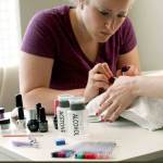 The author applies the second of two coats of gel polish to her sister&rsquo;s nails. Like traditional nail enamel, gel requires a base coat, two coats of color polish and a top coat. Each layer is applied and cured to a hard gel finish via a LED light. (Vanessa McVay / The Herald)
