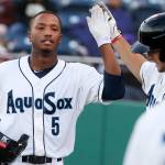 Everett&rsquo;s Johnny Slater (left) is greeted by Onil Pena after hitting a home run in the fifth inning of Monday&rsquo;s game at Everett Memorial Stadium.. (Kevin Clark / The Herald)