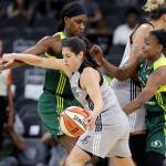 Former Husky and current Stars guard Kelsey Plum drives with the ball during a game against the Storm in San Antonio on June 6. (Associated Press / Eric Gay)