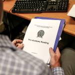 New Everett Police Department recruit Brett Janke goes through a reading packet that covers the basics of police academy. (Ian Terry / The Herald)