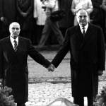 This Sept. 22, 1984 photo shows then French President Francois Mitterrand and German Chancellor Helmut Kohl standing hand-in-hand as they listen to their respective national anthems during a French-German reconciliation ceremony outside the Doaumont cemetery near Verdun. Verdun was the bloodiest battlefield in World War I. (AP Photo, file)