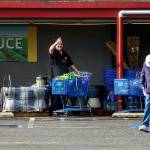 As Williams starts on his morning walk Wednesday, he gets a friendly wave from Tod Jackson, co-owner of Grocery Outlet Bargain Market on Everett Mall Way. (Dan Bates / The Herald)