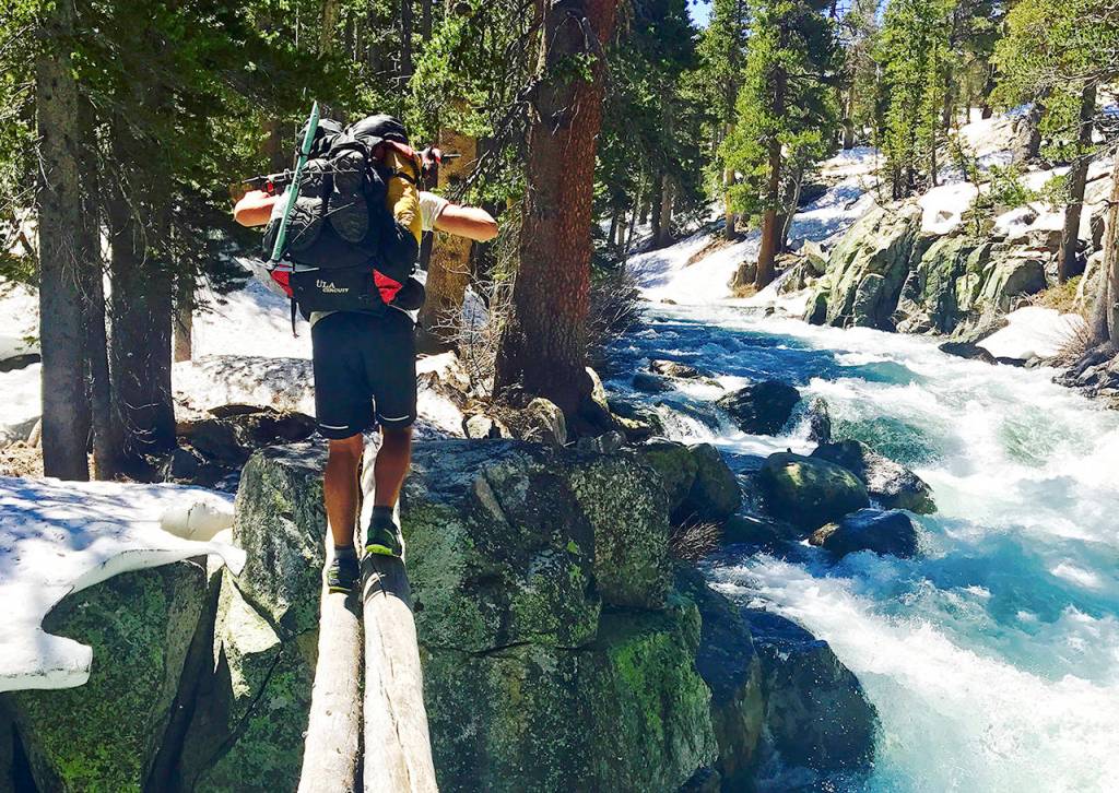 In this June 16 photo, Jake Gustafson crosses Bear Creek along the Pacific Crest Trail near Kings Canyon National Park, California. (Wesley Tils via AP)