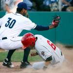 Vancouver&rsquo;s Cullen Large (right) steals home past Everett catcher Michael Suarez Monday at Everett Memorial Stadium. (Kevin Clark / The Herald)
