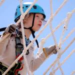 Kaitlyn Nebeker, 8, makes her way through the high ropes course at High Trek Adventures at Paine Field Community Park in Everett. (Kevin Clark / The Herald)