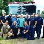 Dale Reiner (center, standing) was saved in April by CPR performed by a family friend and local firefighters after he had a heart attack. He invited the firefighters to his 75th birthday party June 10 to thank them. (Snohomish County Fire District 7)