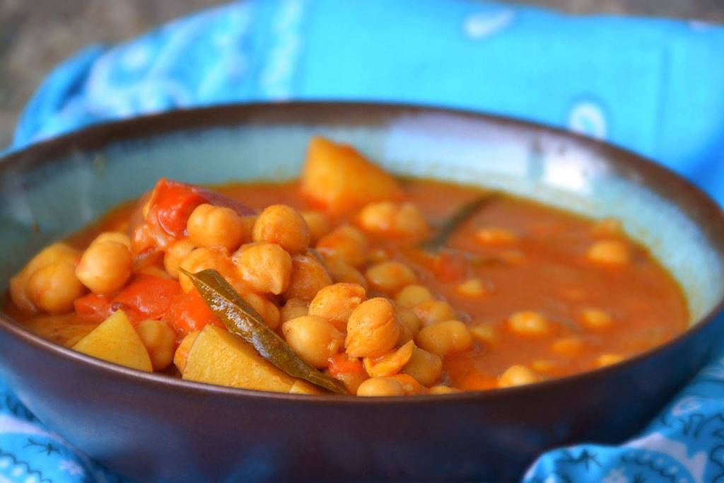 Garbanzo beans and spinach in coconut curry (channa masala) also has thick chunks of potato, eggplant and tomato. (Photo by Reshma Seetharam)