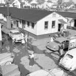 Spring Formal, car wash, with a 1949 Oldsmobile Rocket 88 in the center of the frame. J.F.Marvin Beuchell stands with his back to the camera in front of building 19. (Photo courtesy Everett Community College)