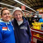 Renee Steuer, a checker at Grocery Outlet Bargain Market on Everett Mall Way, hugs Williams, who begins and ends his daily walk at the store. Each day, Williams gives Steuer his copy of The Daily Herald, which he reads at 4:30 a.m. (Dan Bates / The Herald)